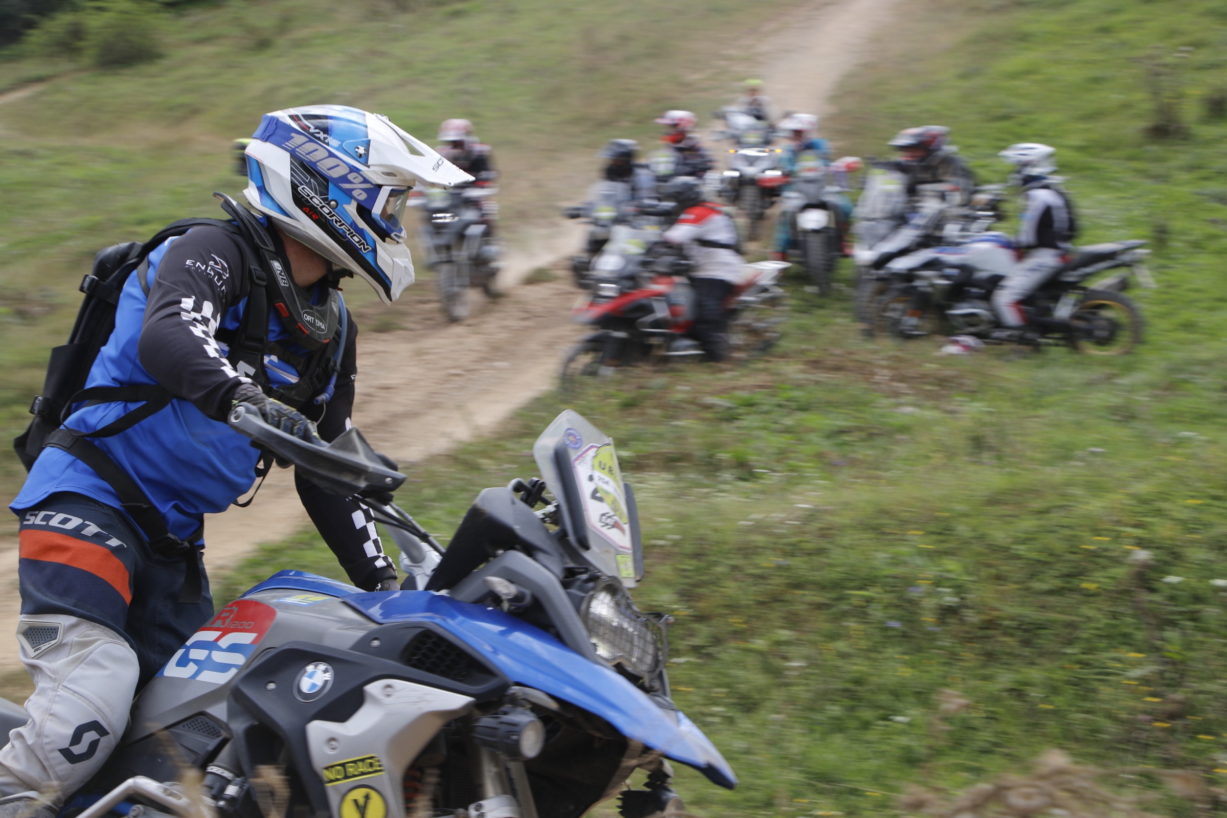 Fahrer mit blauem Helm auf einer BMW GS im Gelände